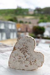 French heartshaped neufchatel cow cheese with mold on white paper, Normandy, France