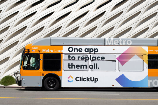 Los Angeles, CA, USA - May 11, 2022: ClickUp advertising is seen on a bus in Los Angeles, California. ClickUp lets freelancers to send and receive mails while managing their work in one place.