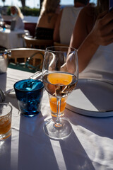 Dinner at sunset in French restaurant with cold dry rose wine in Port Grimaud, summer vacation on French Riviera, France