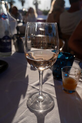 Dinner at sunset in French restaurant with cold dry rose wine in Port Grimaud, summer vacation on French Riviera, France