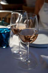 Dinner at sunset in French restaurant with cold dry rose wine in Port Grimaud, summer vacation on French Riviera, France