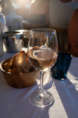 Dinner at sunset in French restaurant with cold dry rose wine in Port Grimaud, summer vacation on...