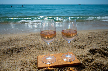 Cold rose wine from Provence served outdoor on white sandy beach Plage de Pampelonne near Saint-Tropez, France