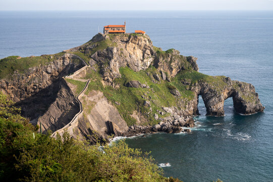 Stone footpath to famous landmark and film location in North of Spain, ocean islet with chapel San juan de gaztelugatxe, Basque Country, Spain