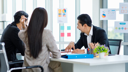 Millennial Asian professional successful bearded businessman in formal suit brainstorming...
