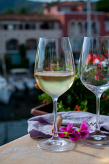 Drinking of cold white wine  with view on yacht harbour of Port Grimaud, summer vacation on French Riviera, France