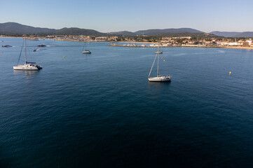 Aerial view on Gulf of Saint-Tropez, sail boats, houses of Port Grimaud and Port Cogolin, summer vacation in Provence, France