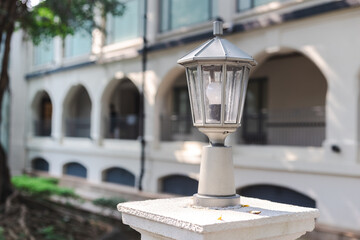 white old street lamp on the street, under sunlight
