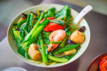 A bowl of shrimp, seafood and vegetable soup