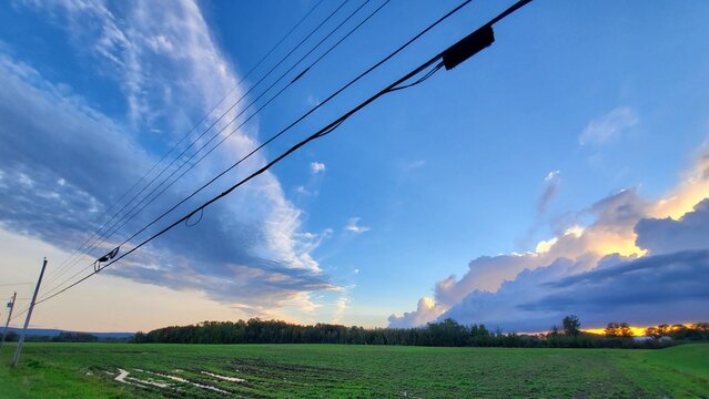 Blue and Golden Clouds Stretch Across Green Field, Nova Scotia