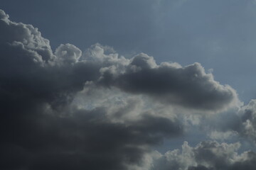 Naklejka na ściany i meble telephoto shot of backlit clouds in the sky texture background