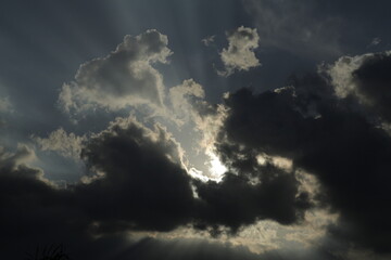 Fototapeta na wymiar telephoto shot of backlit clouds in the sky texture background