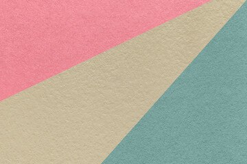 Fototapeta na wymiar Texture of old craft beige, blue and pink color paper background, macro. Vintage abstract cerulean cardboard.