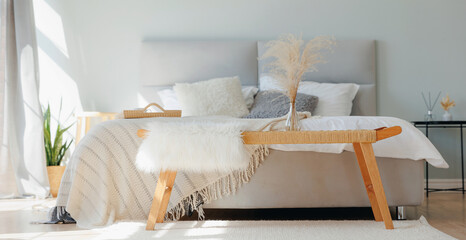 Morning light White room bedroom scandinavian interior design banner. Grey bed with folding breakfast table © Parilov