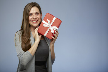Happy smiling woman holding gift box. Isolated female portrait.