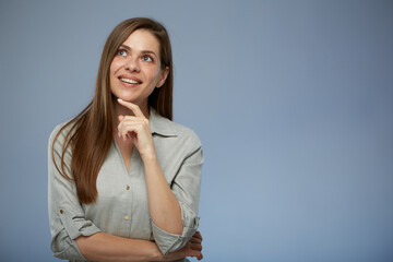Confident positive thinking business woman looking up. isolated portrait of smilng young lady.