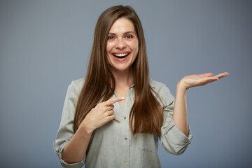 Smiling business woman holding empty hand and pointing finger. isolated female portrait.