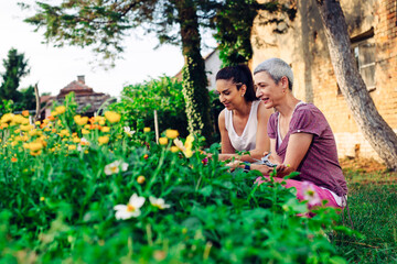 Fototapeta premium Mother and daughter gardening together.Gardening discovering and teaching.