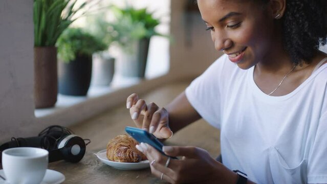 Cafe girl with phone scroll on social media app, website or news feed while relax in Jamaica coffee shop, restaurant or store. Mobile smartphone, smile and happy black woman browsing online webpage