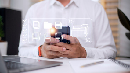 Document Management System (DMS) being setup by IT consultant working on laptop computer in office. Software for archiving, searching and managing corporate files and information