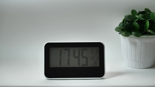 Modern mirror clock, with a thermometer, hydrometer standing on white background. Time is fleeting