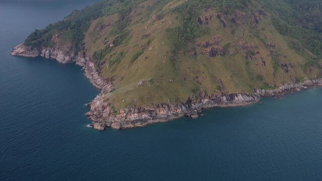 Aerial view of blue sea with green hill at twilight in Laem Krating cape, Phuket , Thailand