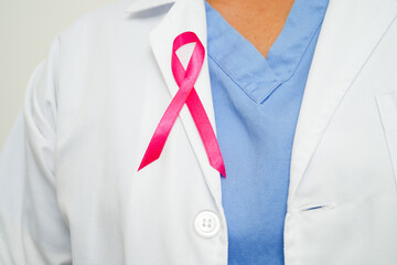 Asian woman doctor with pink ribbon, World Breast Cancer Day at October.