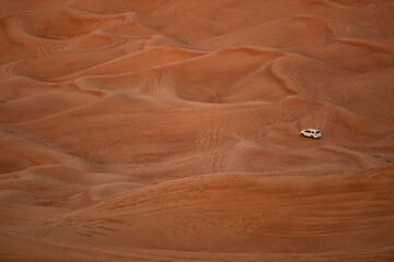 Four wheel drive vehicle carrying tourists on a tour of the sand dunes Dubai