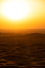Fototapeta na wymiar View of sand dunes criss crossed with vehicle tracks Dubai