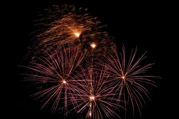 Festive fireworks. Bright beams of exploding pyrotechnics against black night sky.