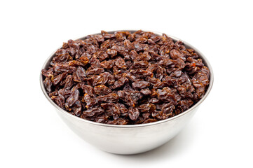 Dark-colored raisins lying in a metal container, shot on a white background.