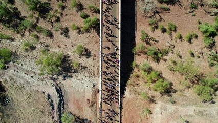 Overhead drone view of people in the Freedom Day Festival march in the remote community of Kalkaringi, Northern Territory, Australia. 26 August, 2022