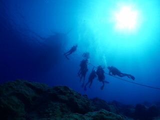 scuba divers around the boat for diving underwater scenery ocean