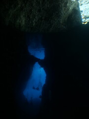 exploring and enjoying the caves underwater cave dive blue background