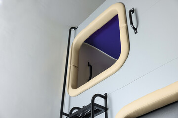 Capsule in modern pod hostel, low angle view