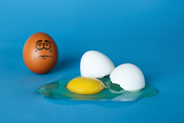 Whole egg with sad face and broken one on blue background