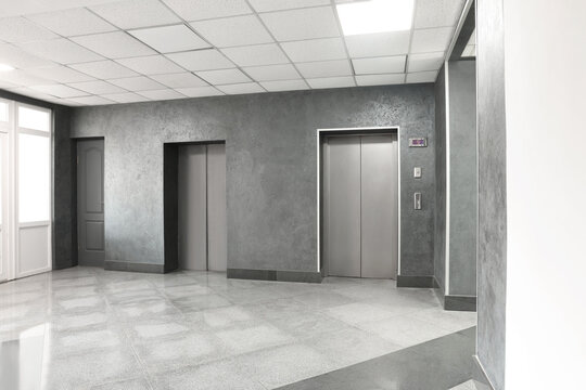 Closed stylish elevator doors in clean hall