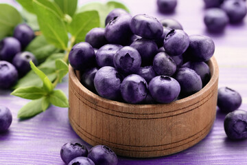 Tasty fresh blueberries on wooden table, closeup
