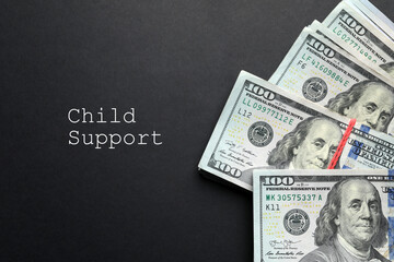 Child support concept. Many dollar banknotes on black background, flat lay