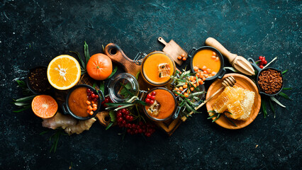 Autumn food concept: berries, honey, citrus fruits. Foods with a high content of vitamin C. On a dark background. top view