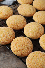 Many tasty sugar cookies on wooden table, closeup