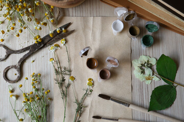 Flat lay composition with beautiful dried flowers and books on wooden table
