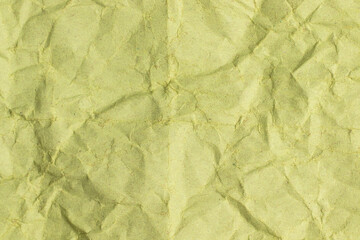 Green crumpled kraft paper background. Full frame texture.