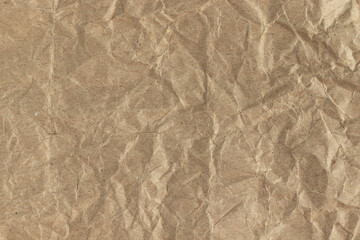 Brown crumpled kraft paper background. Full frame texture.