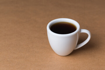 A single coffee cup on brown background