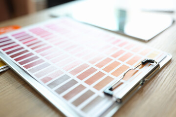 Samples of color catalog and different shades of colors on office table