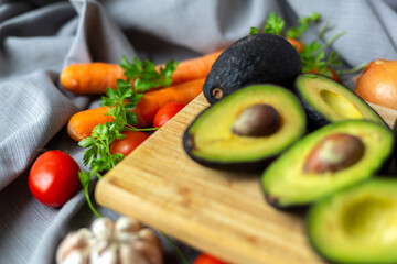 Vegetables for vegan salad. Avocado, Carrot, Tomatoes, Garlic, Onion, Parsley.
