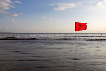 Red flag on the beach swimming forbidden