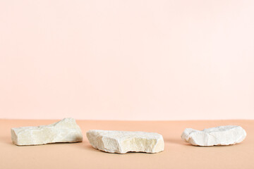 Stone podiums on a beige background. Abstract eco-showcase for organic products