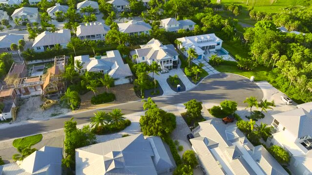 View from above of large residential houses in closed living golf club in south Florida. American dream homes as example of real estate development in US suburbs